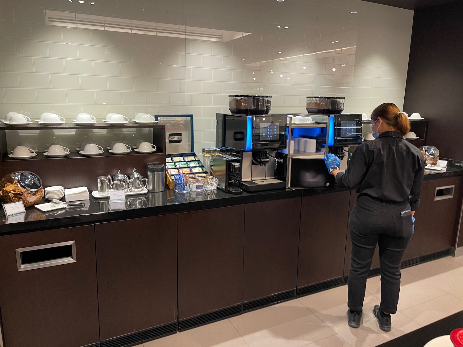 a woman standing at a counter with a machine