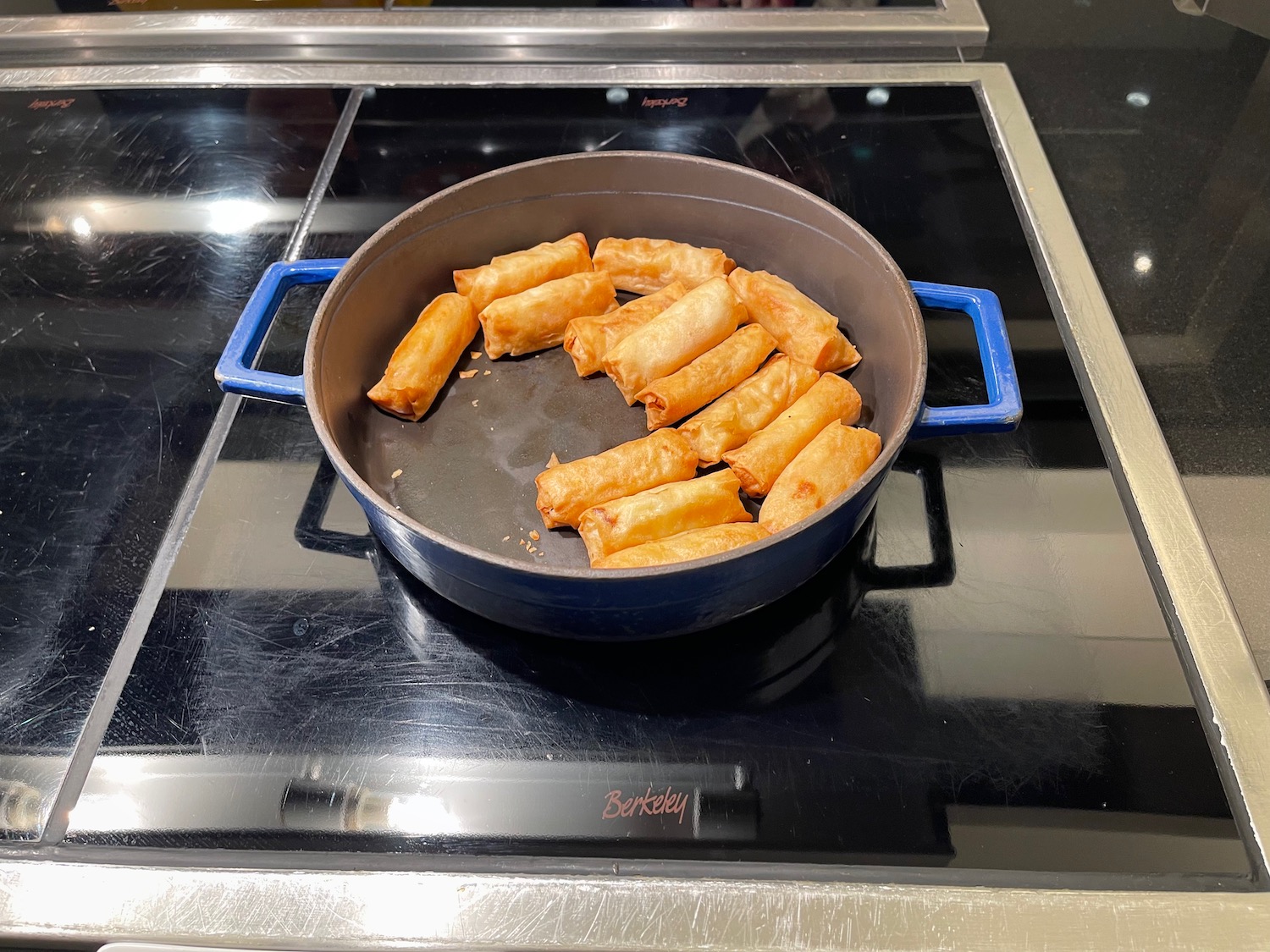 a pan of fried spring rolls