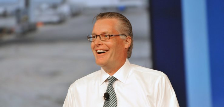 a man wearing glasses and a white shirt