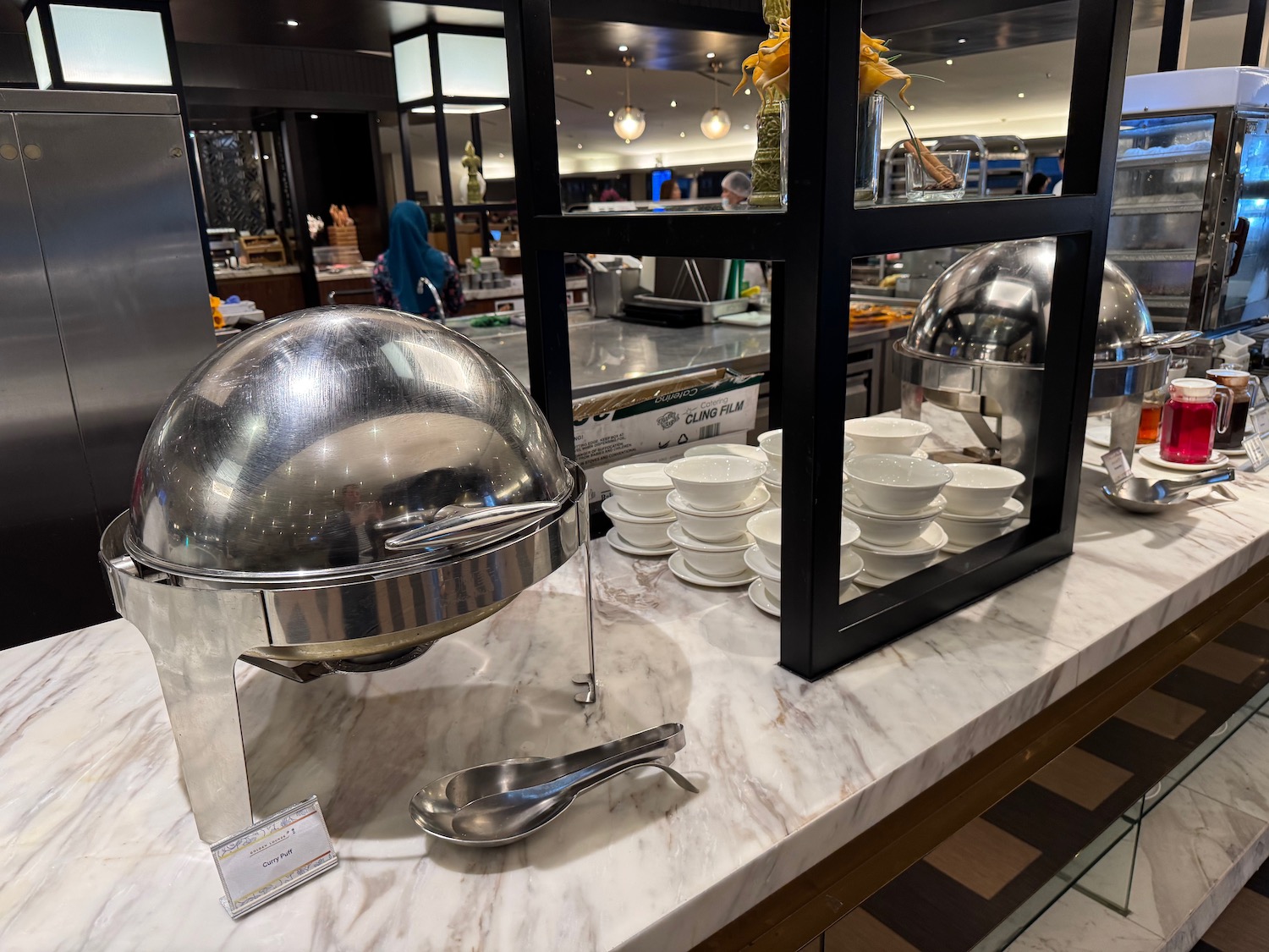 a buffet with a bowl and spoons