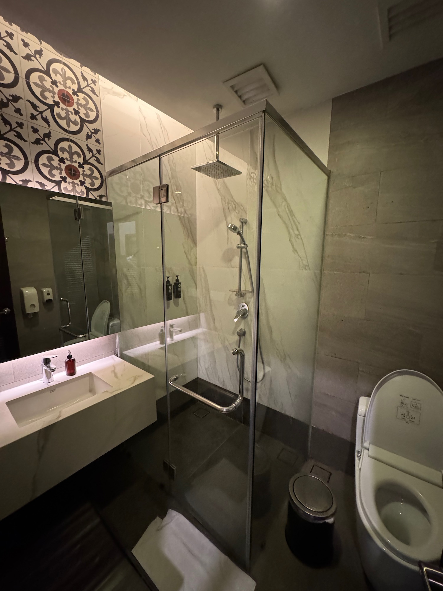 a bathroom with a glass shower and sink