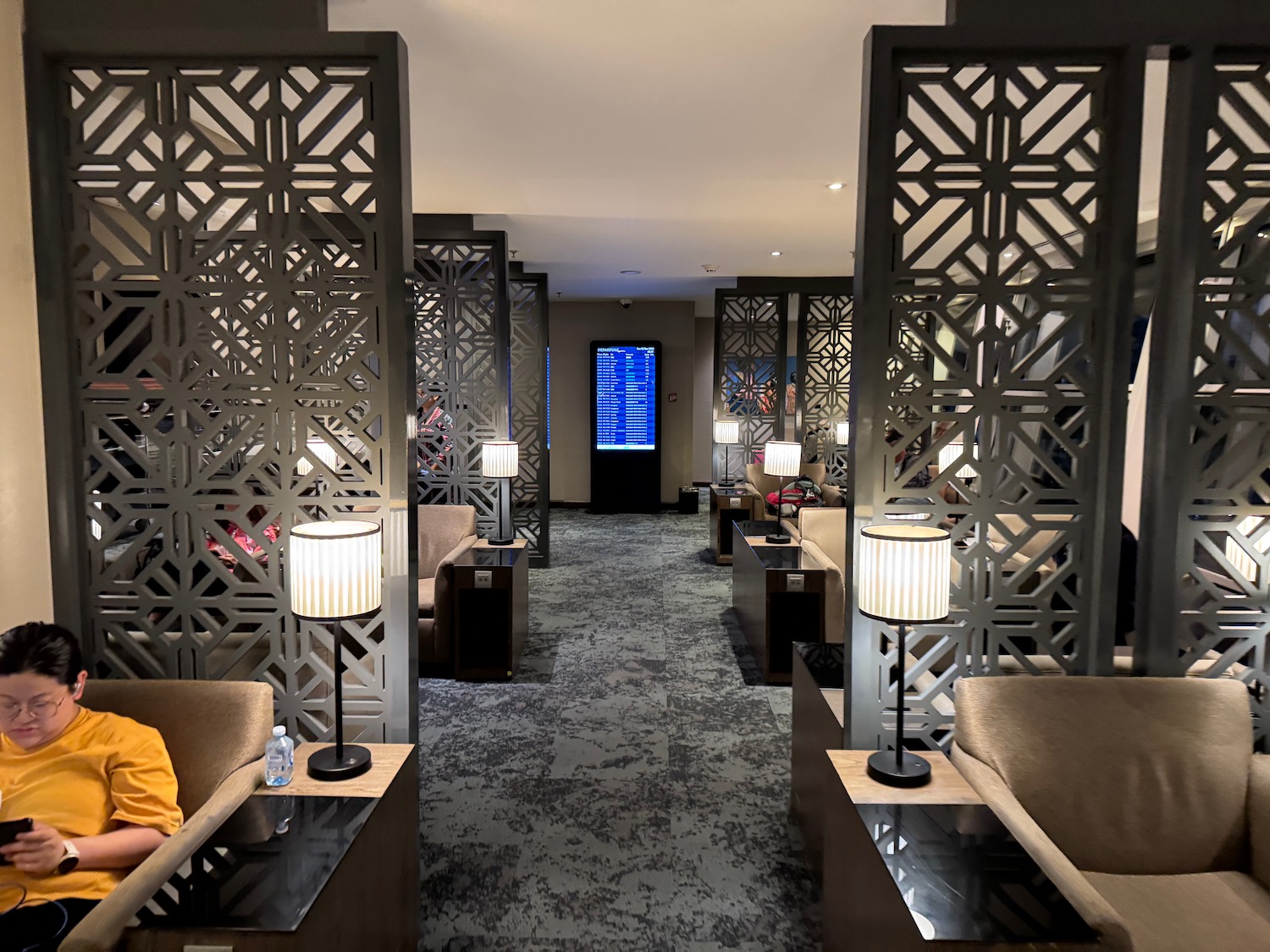 a room with chairs and lamps