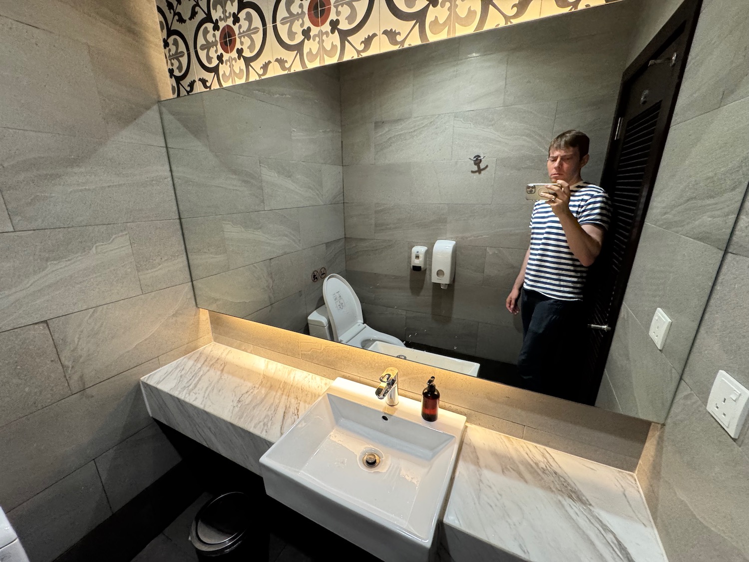 a man taking a selfie in a bathroom