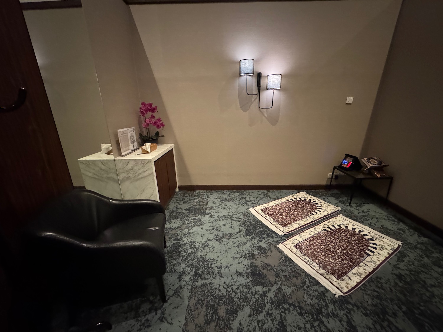 a room with a chair and rugs