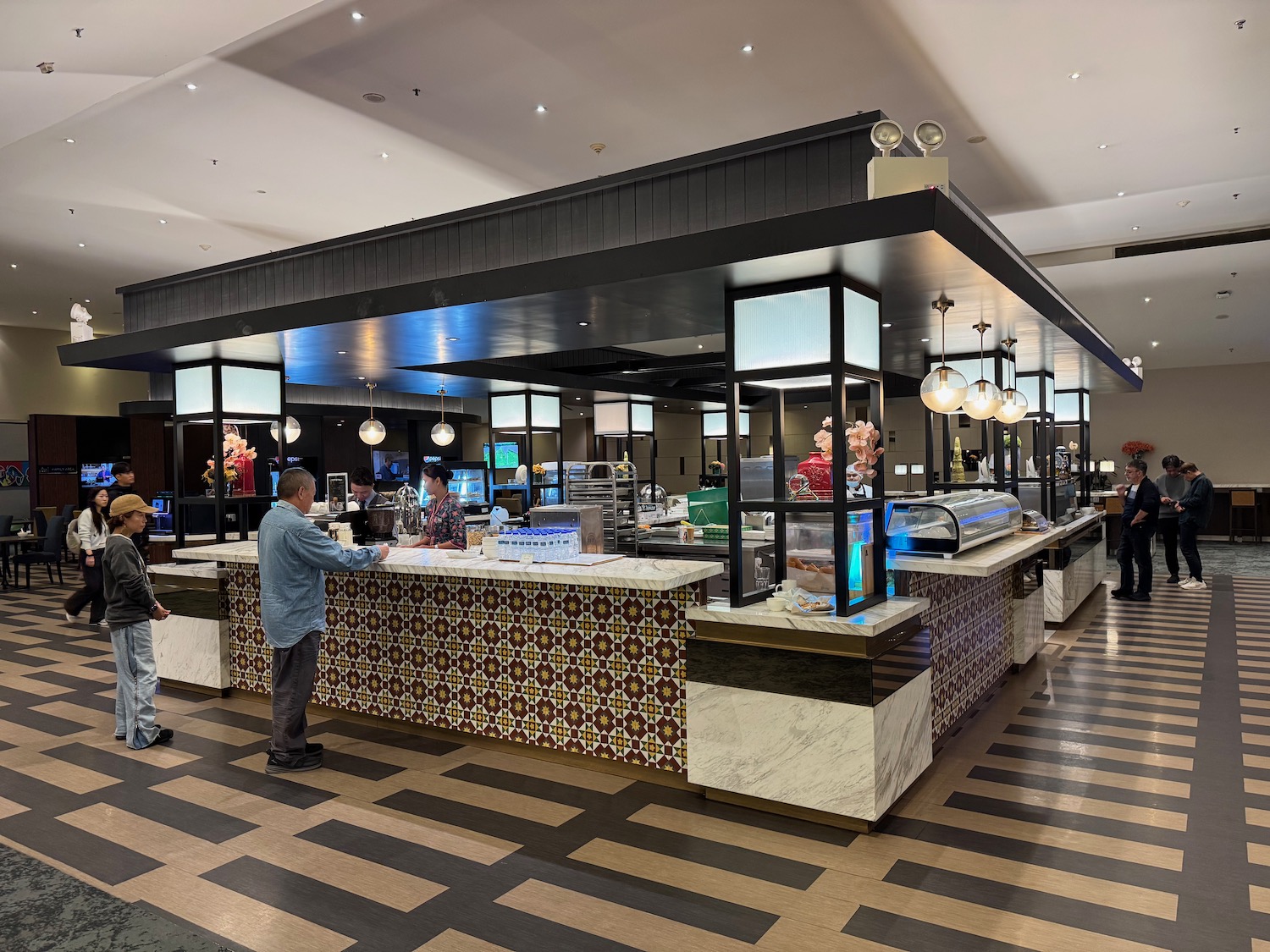 a food court with people standing in front of it