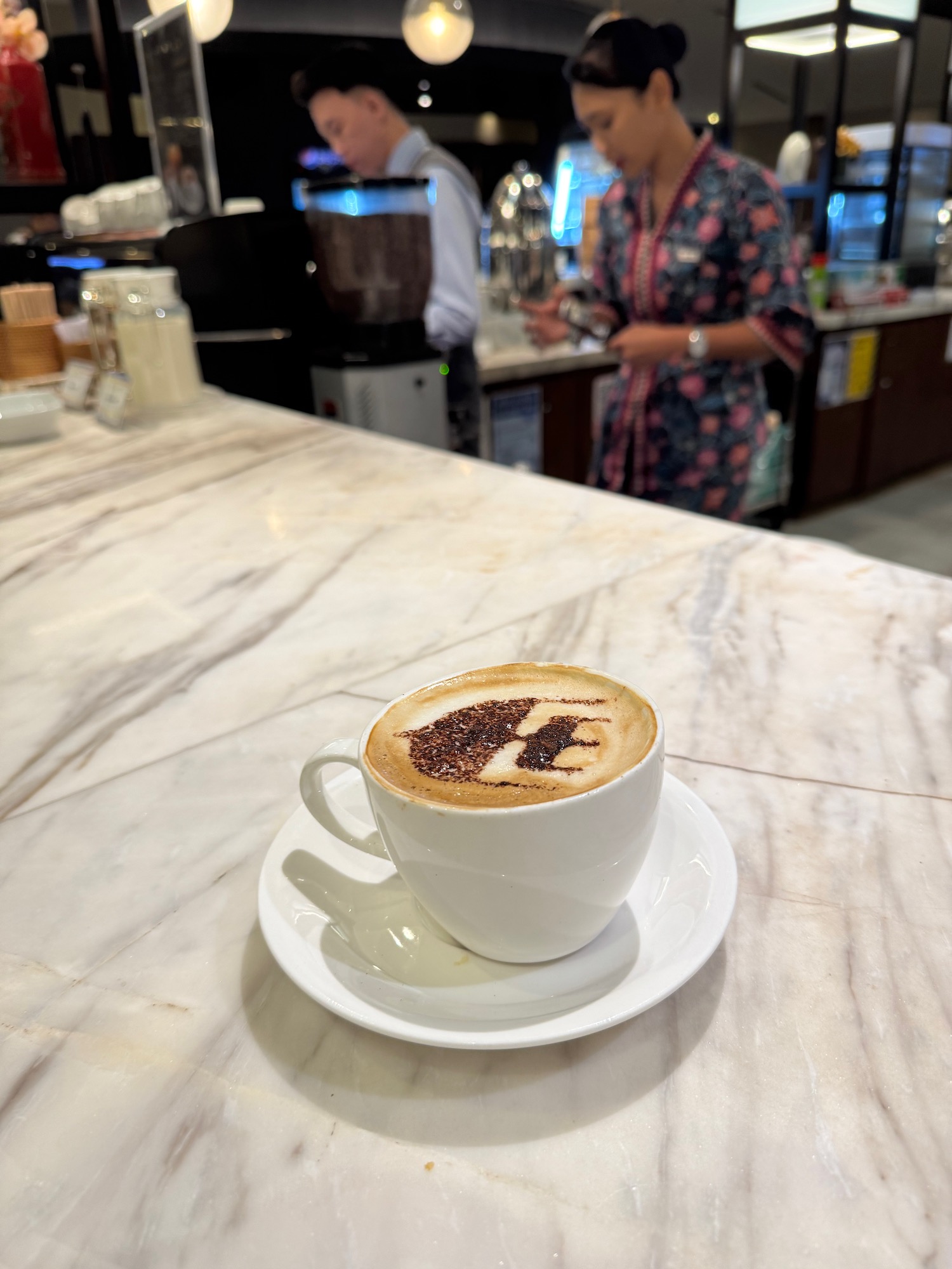 a coffee cup with a design on the foam
