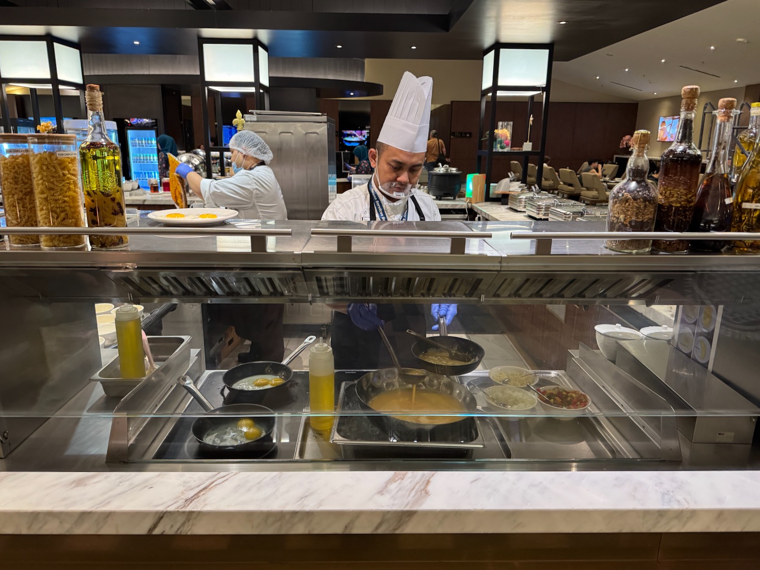 a group of people cooking in a kitchen