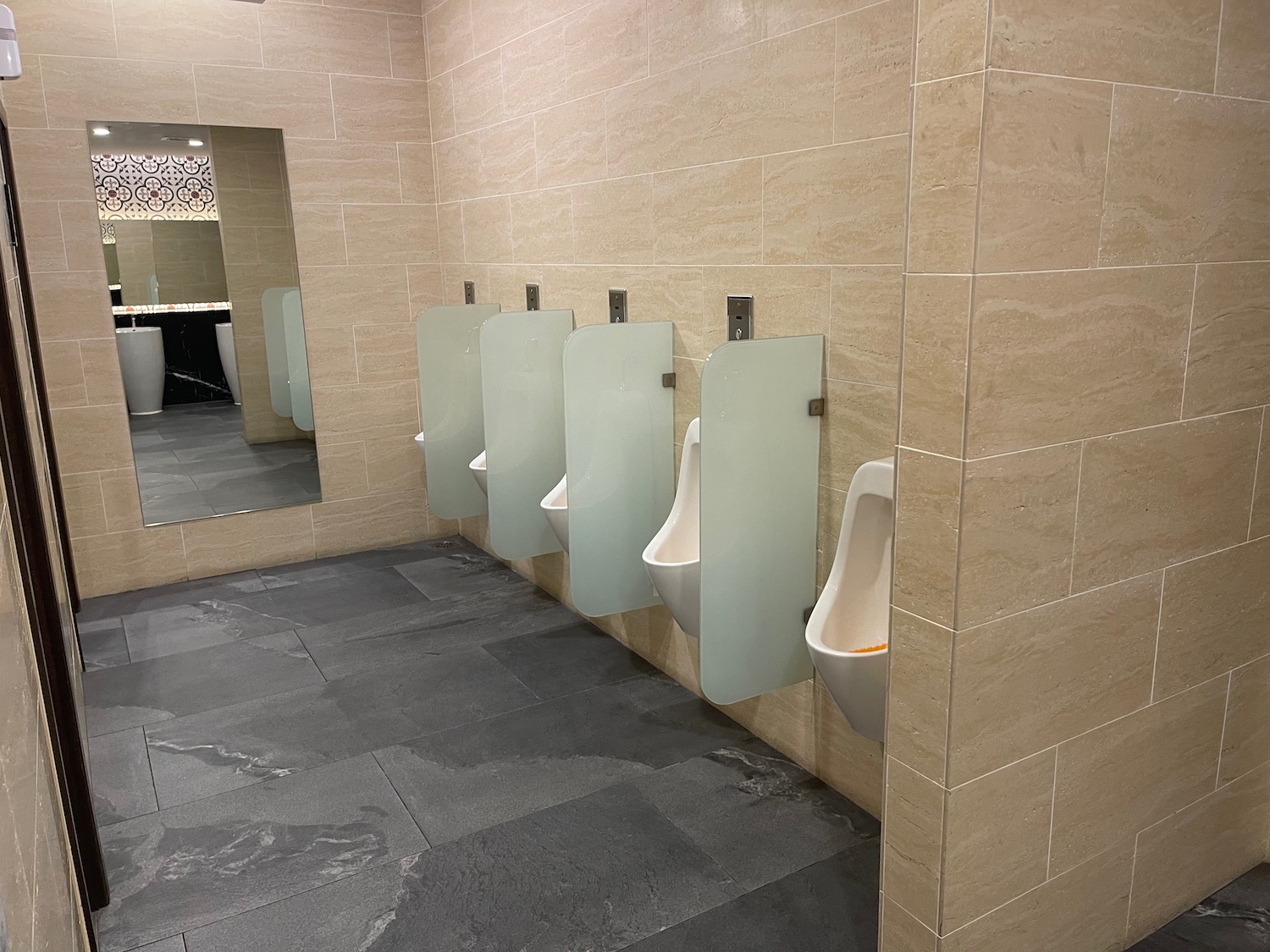 a row of urinals in a bathroom