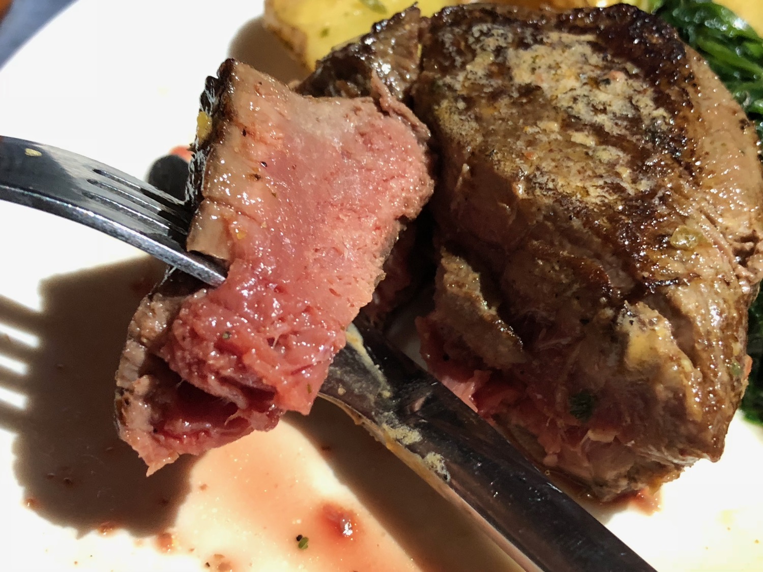 a fork and knife on a piece of meat