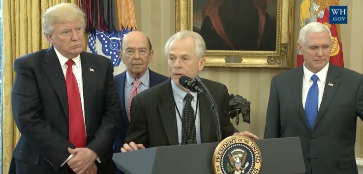 a man standing at a podium with a microphone