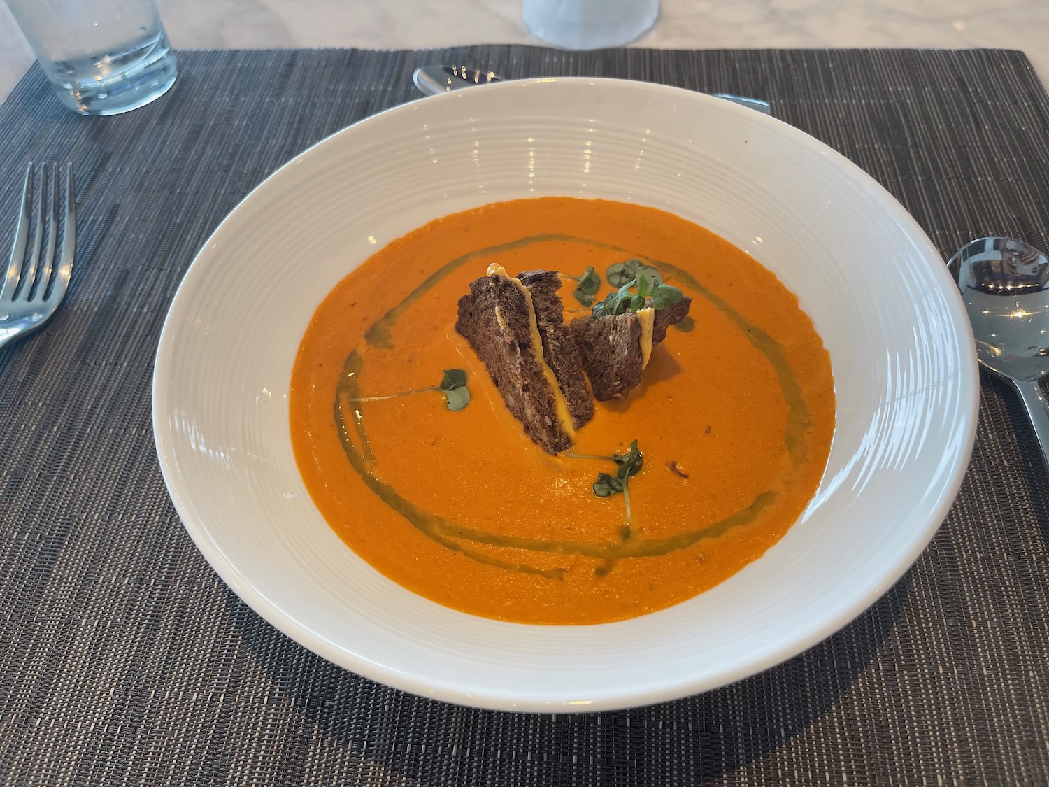 a bowl of soup with a piece of bread on top