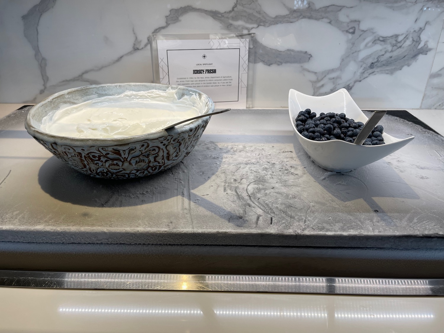 a bowl of yogurt and blueberries on a counter