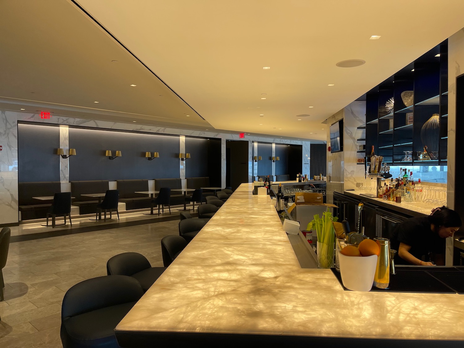 a bar with chairs and tables in a room