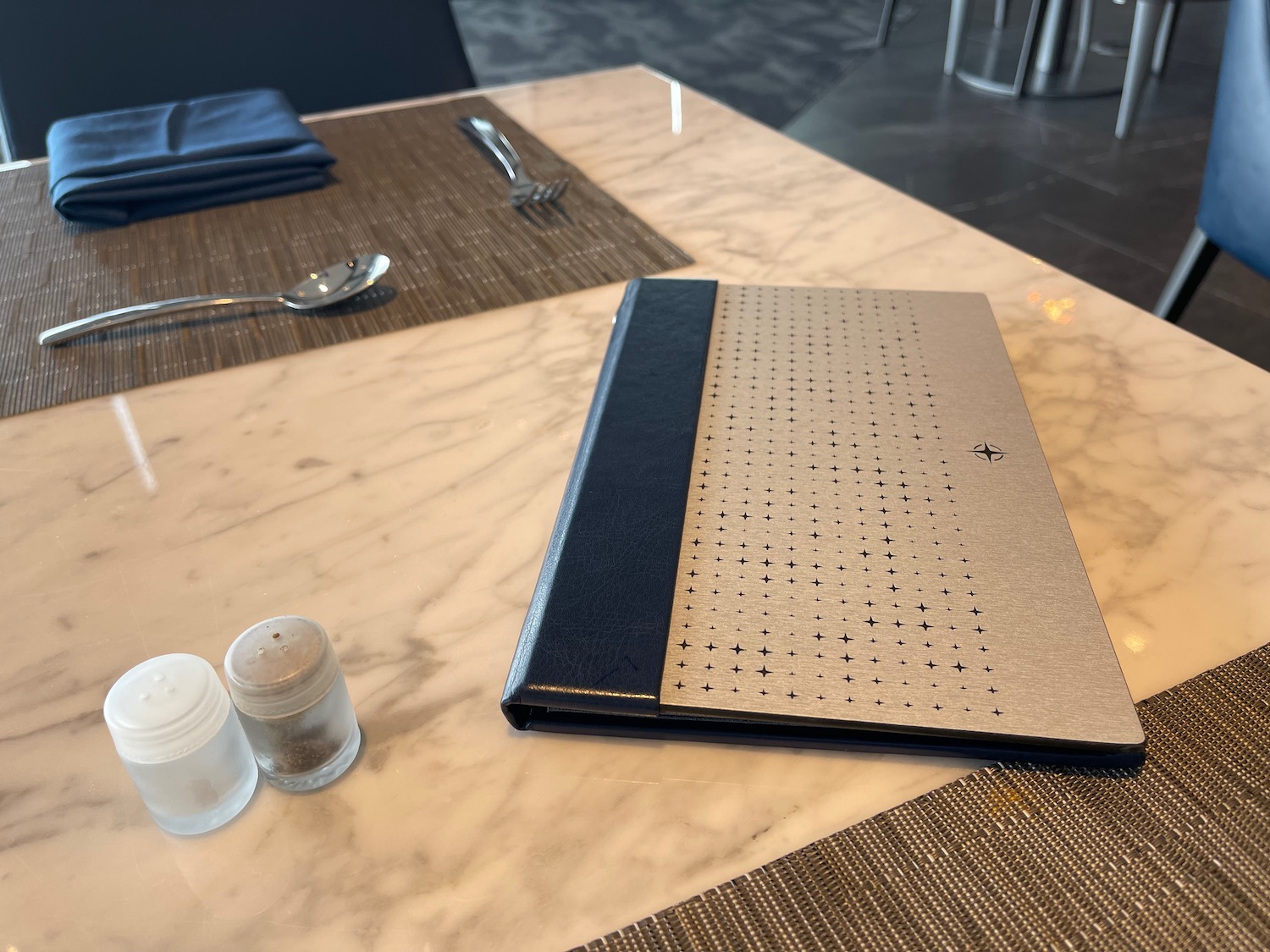 a silver and black folder on a table