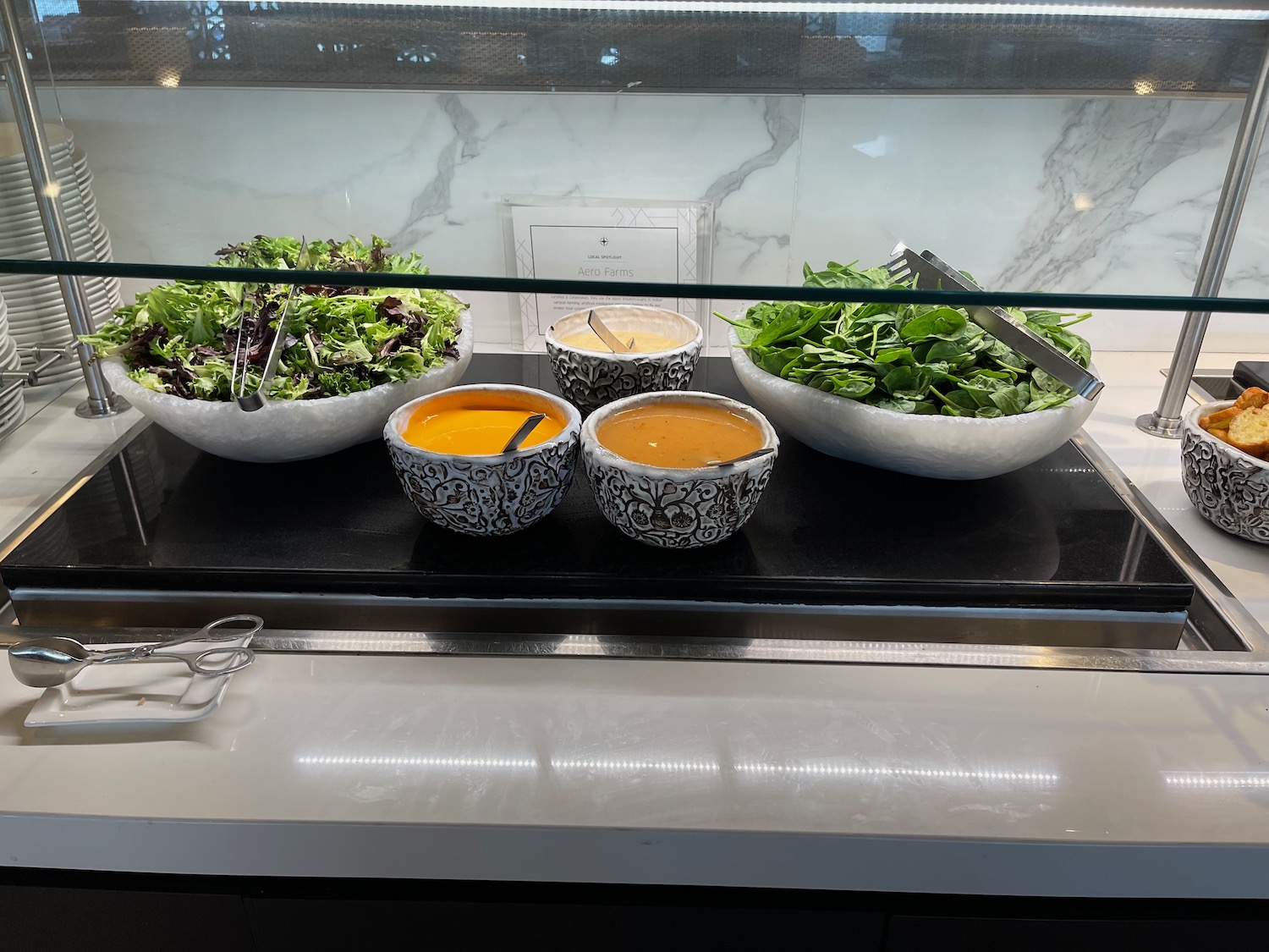 bowls of salad and soup in bowls on a counter