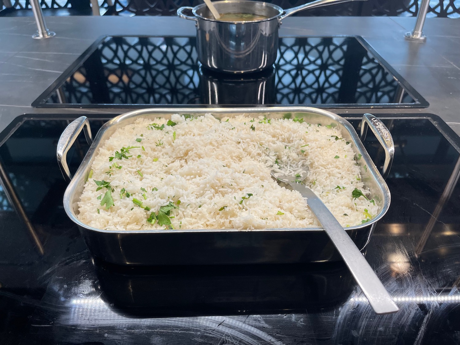 a pan of rice and a pot of soup