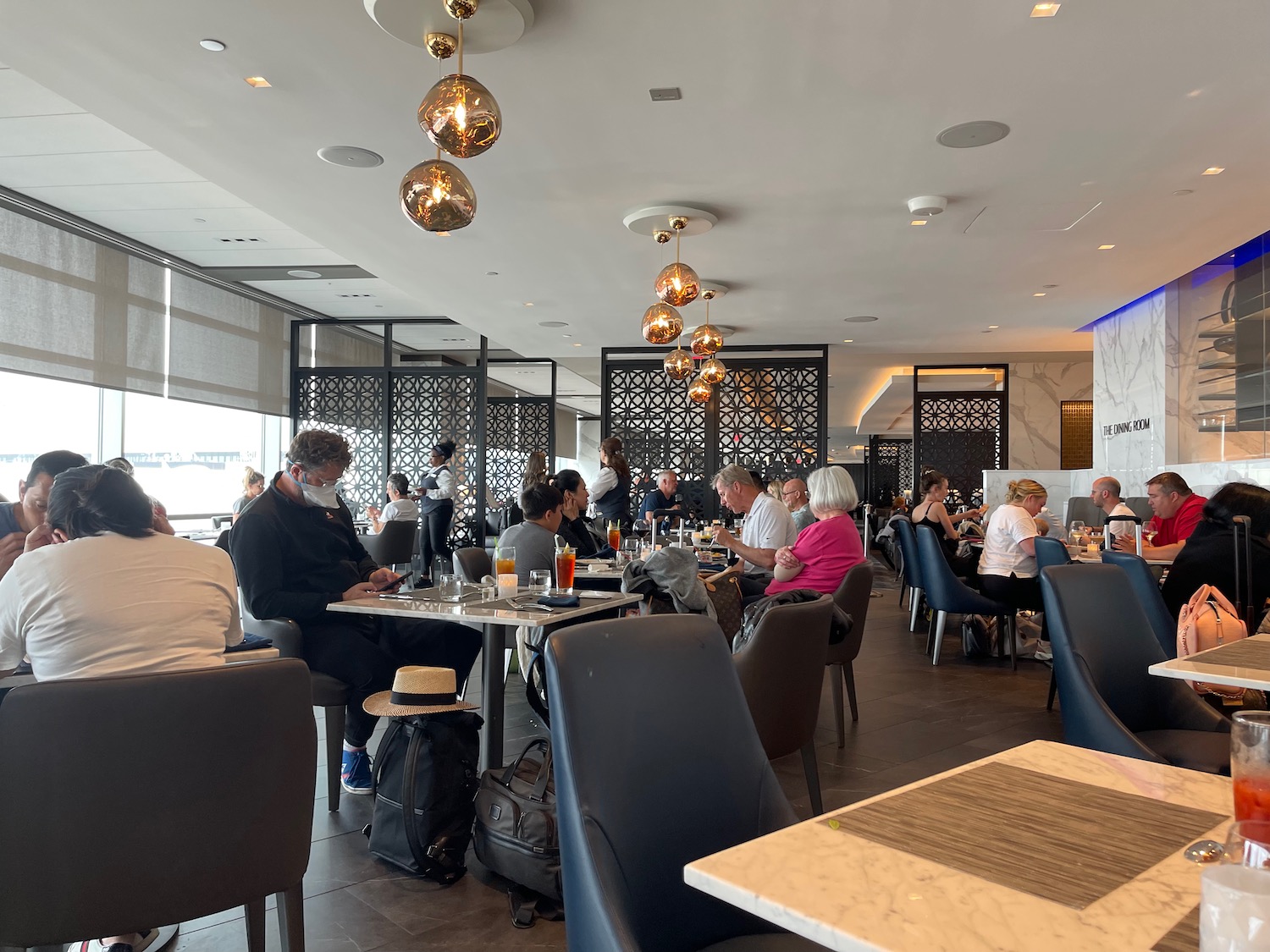 a group of people sitting at tables in a restaurant