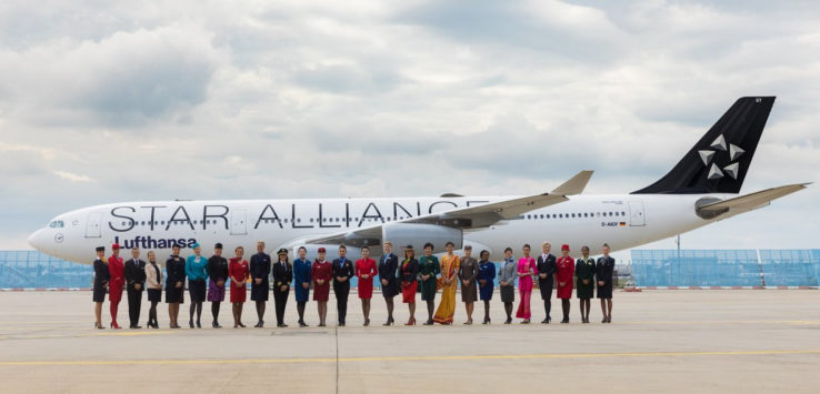 a group of people standing in front of an airplane