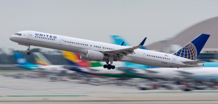 a white airplane flying in the air