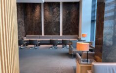 a room with a large wall and chairs