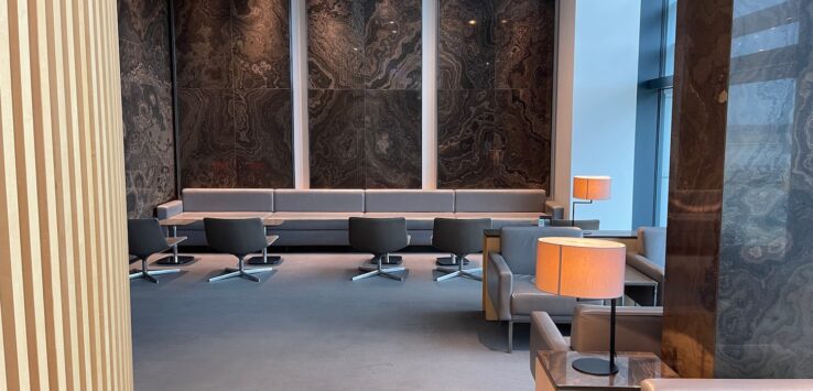 a room with a large wall and chairs