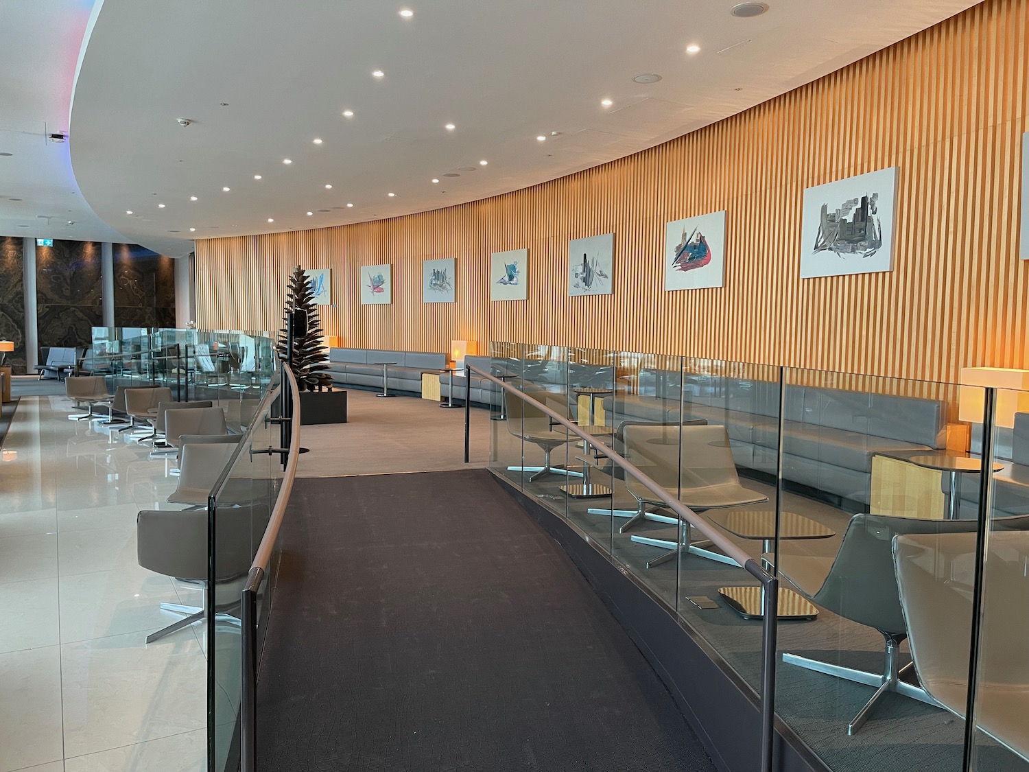 a room with a glass railing and chairs