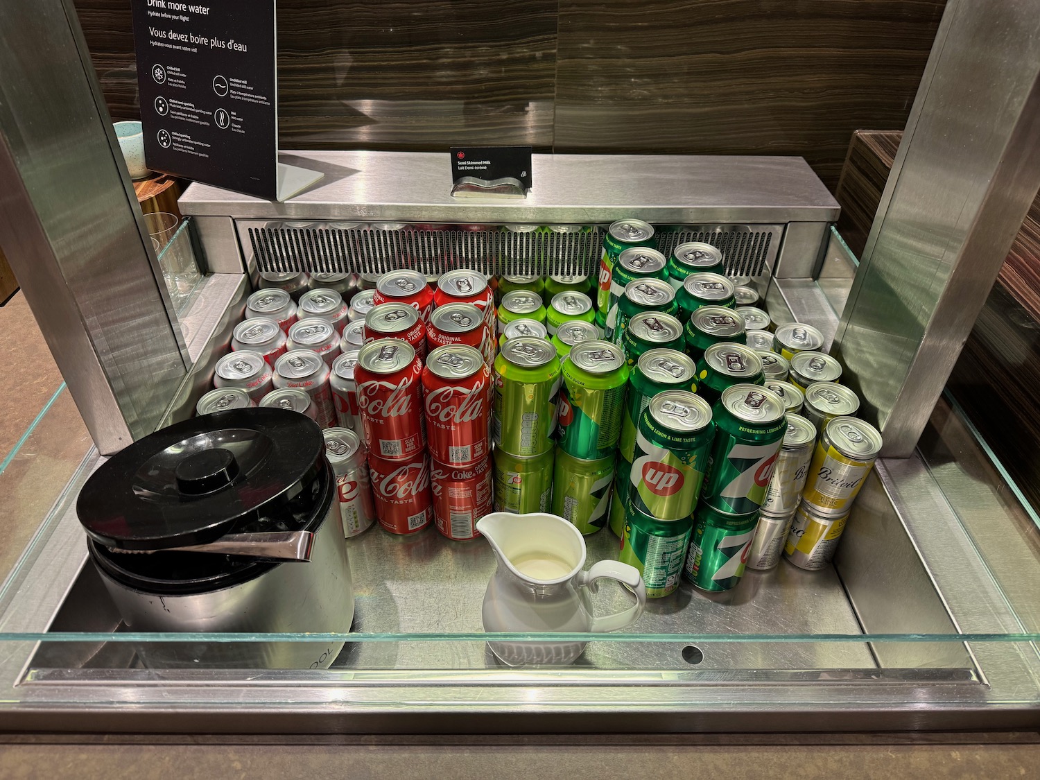 a group of cans and a pitcher in a cooler