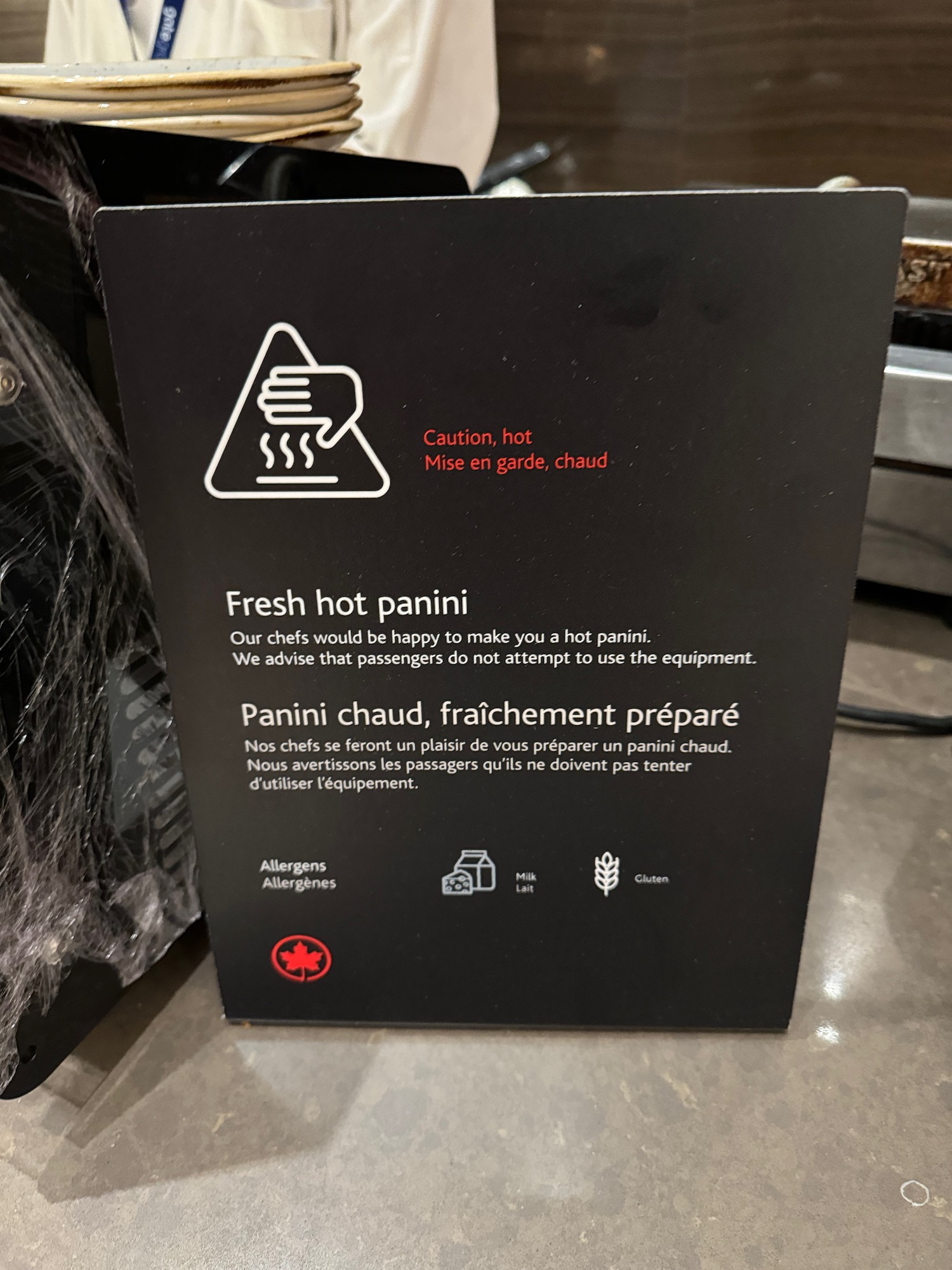 a black sign with white text and red text