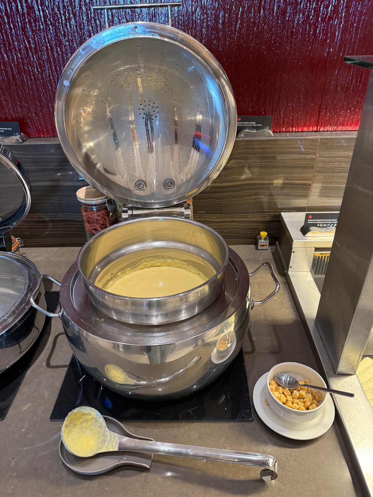 a large metal pot with a lid open