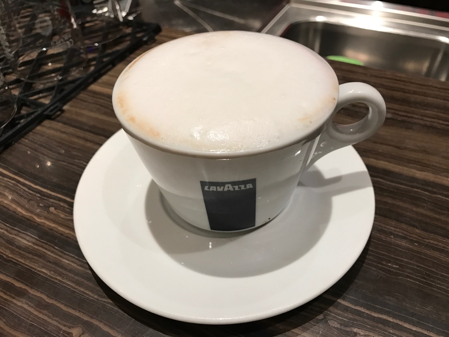 a white cup with foam in it