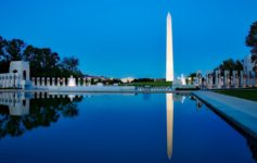 a large monument with a body of water in front of it