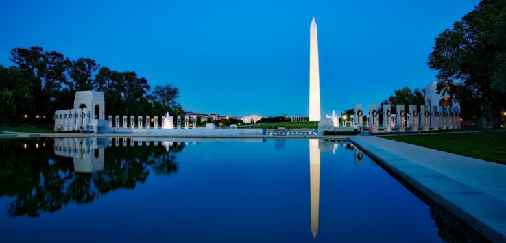 a large monument with a body of water in front of it