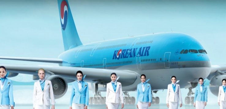 a group of women in uniform standing in front of a plane