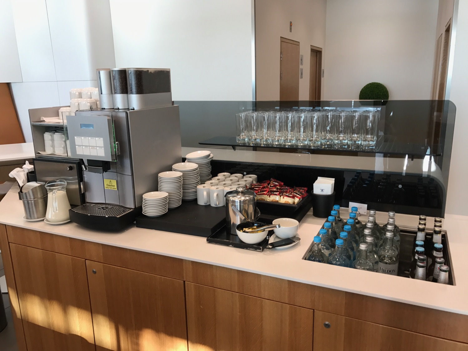 a coffee machine and cups on a counter