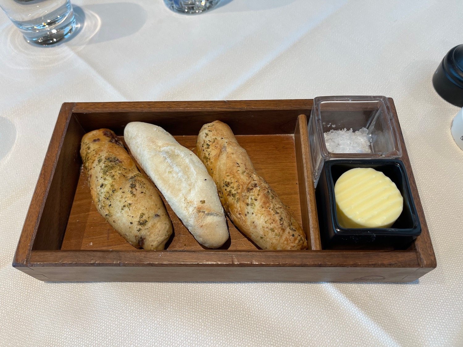 a wooden tray with food in it