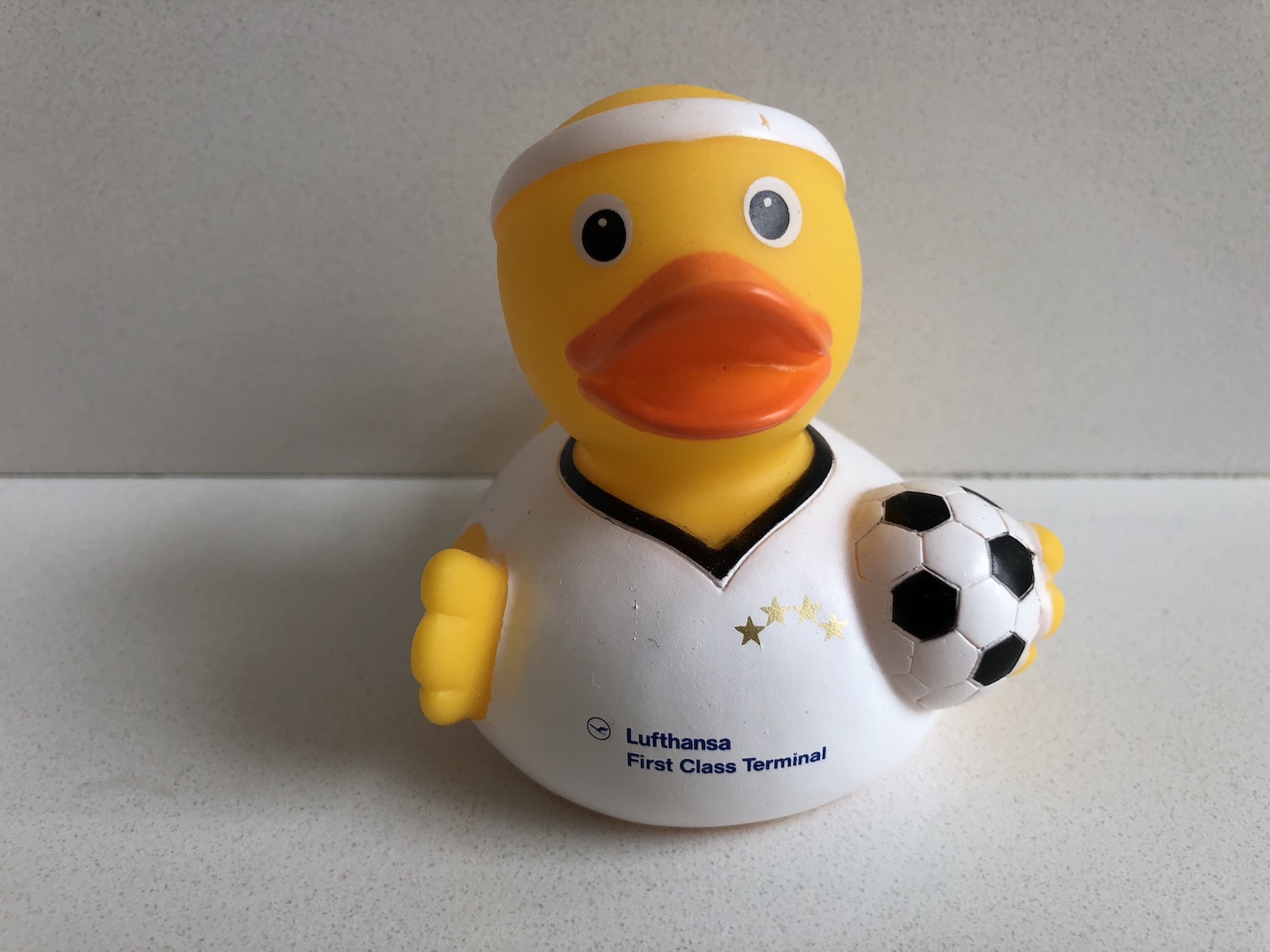 a yellow rubber duck with a football ball
