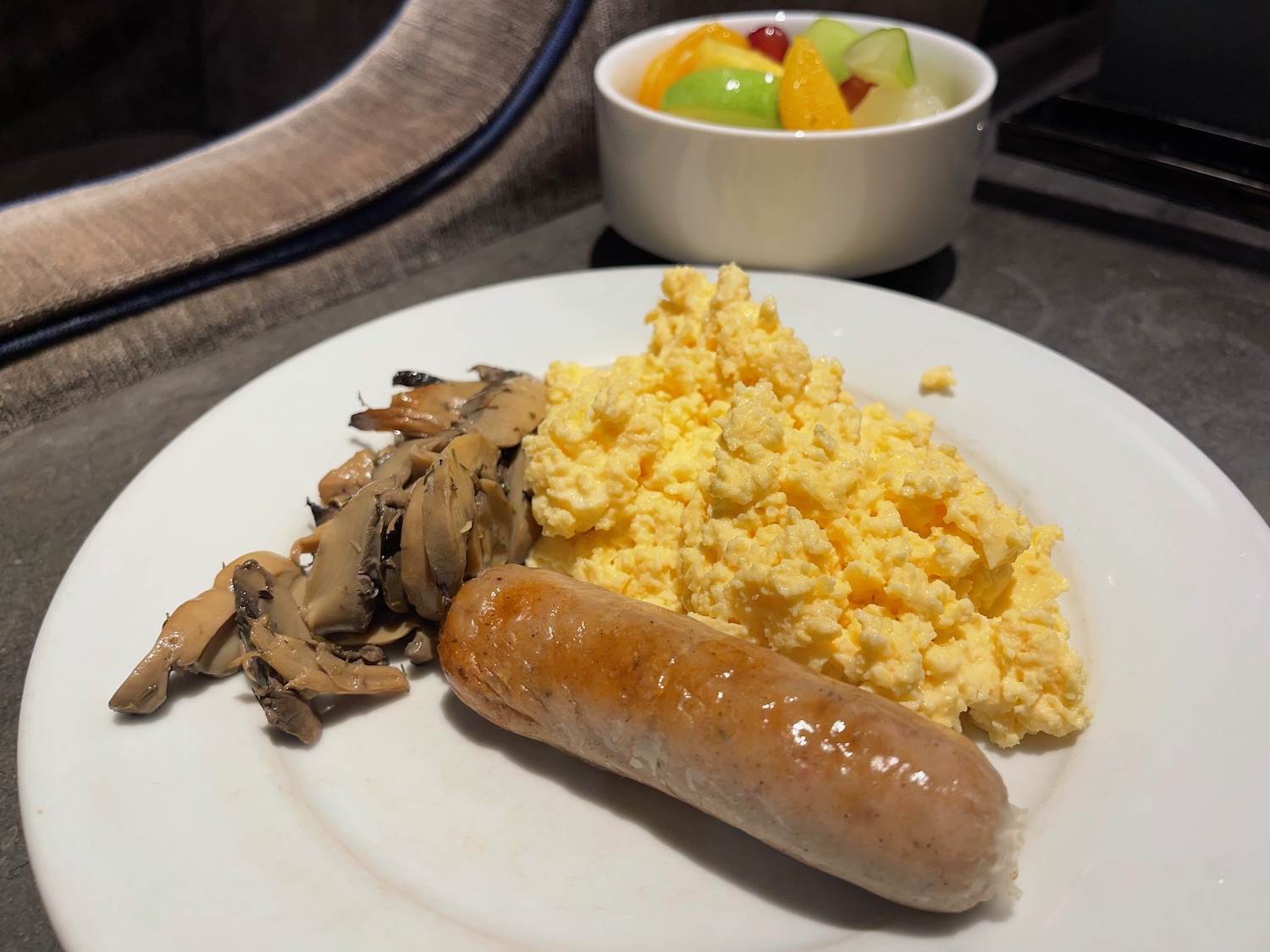a plate of food with sausage and eggs
