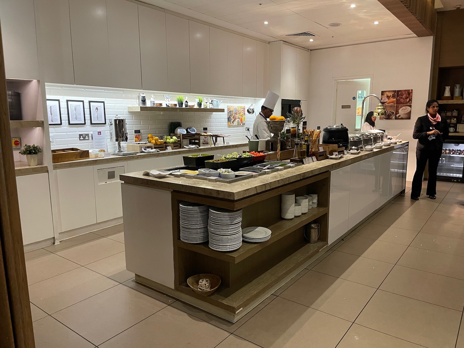 a kitchen with a chef in the background