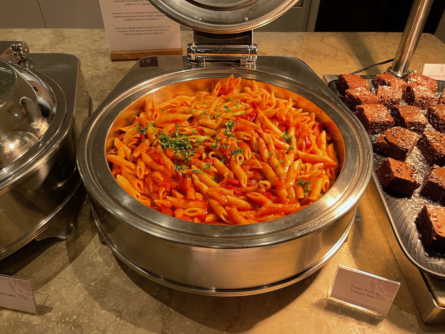 a bowl of pasta with sauce and parsley in it