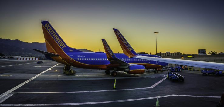 two airplanes parked on a runway