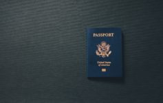 a blue passport on a black surface