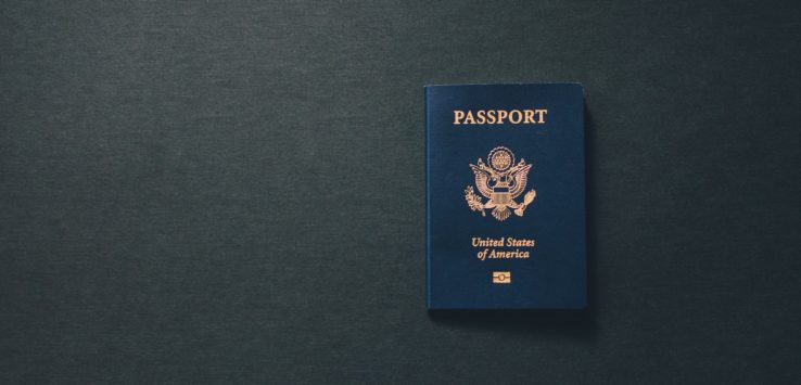 a blue passport on a black surface