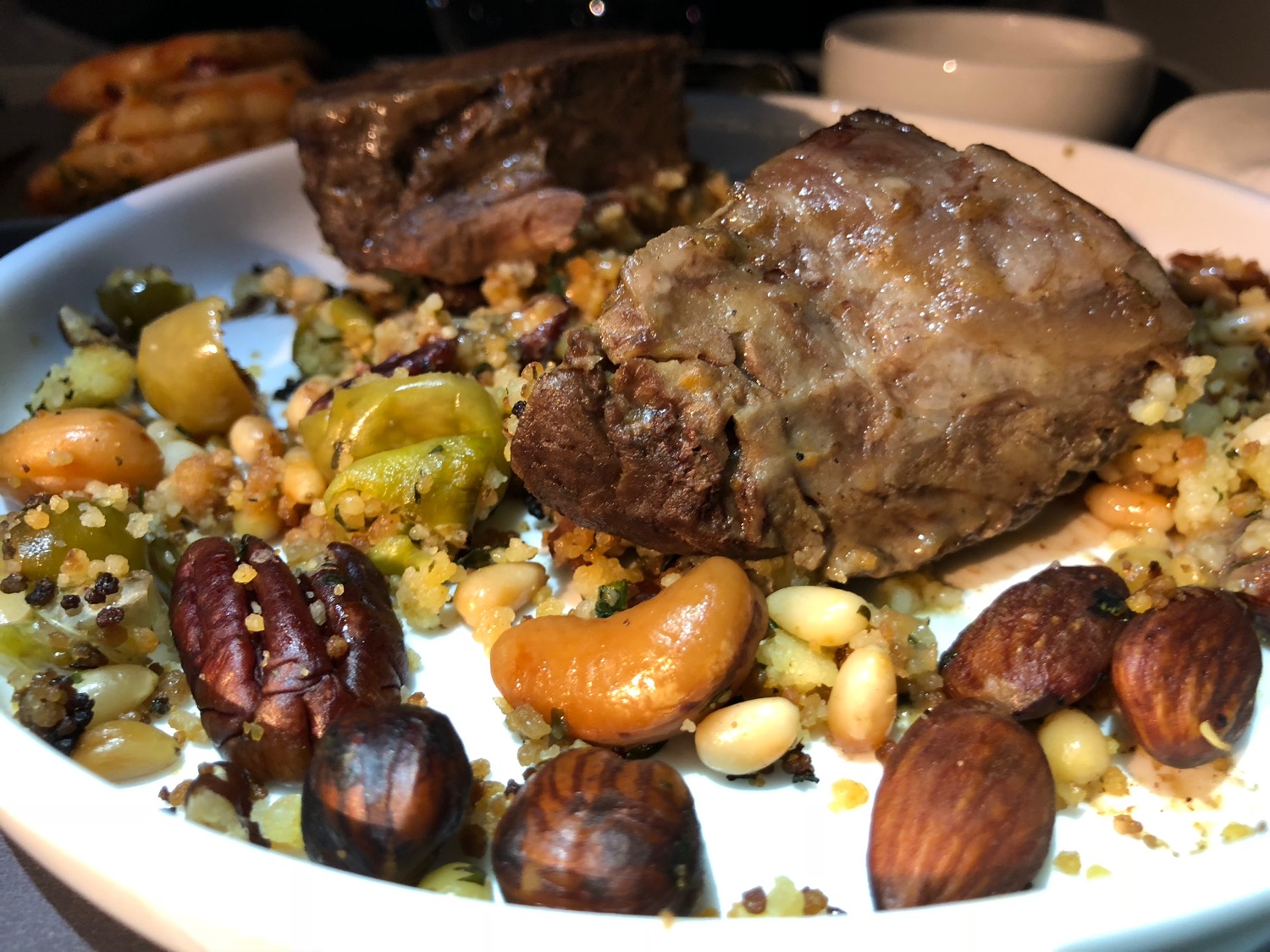 a plate of food with meat and nuts