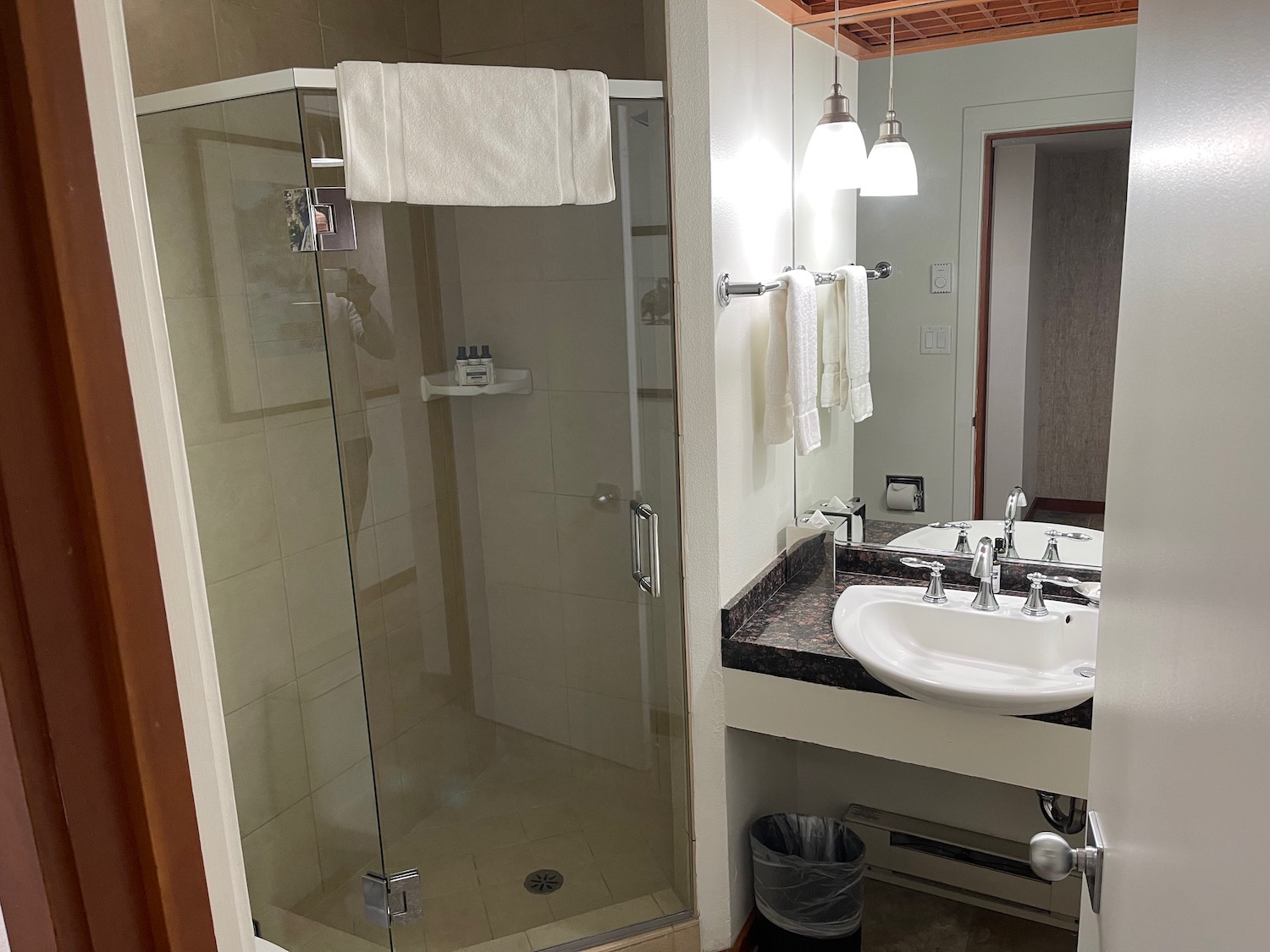 a bathroom with a glass shower and sink