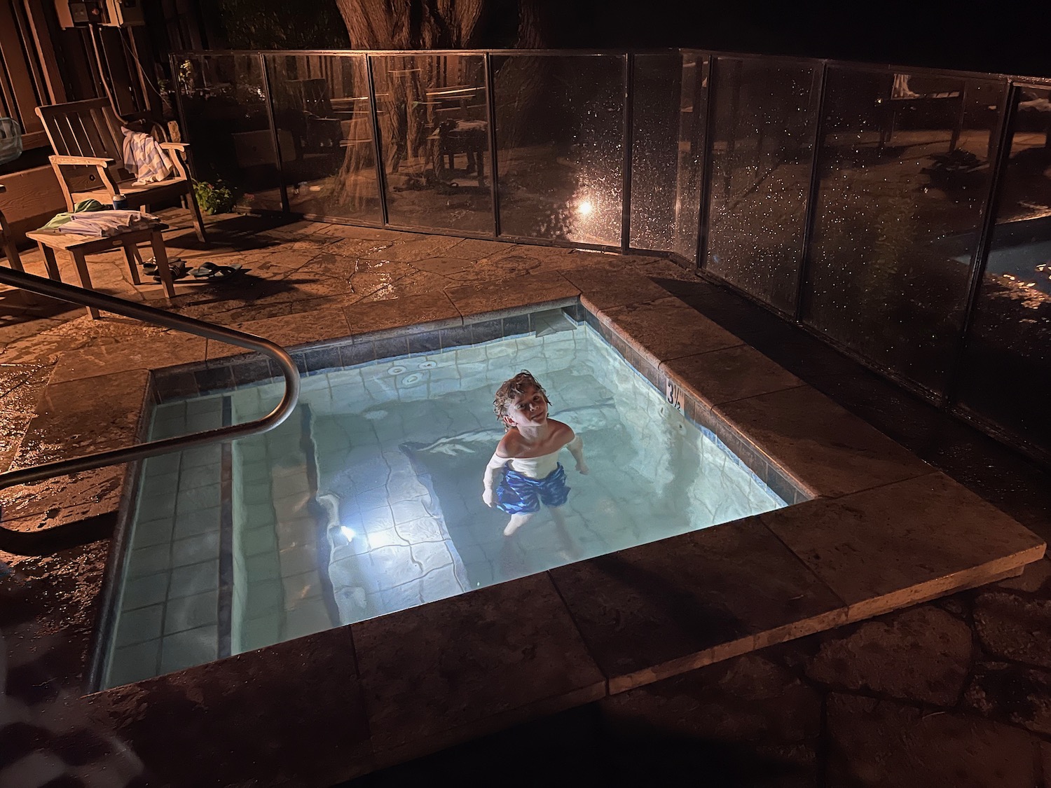 a boy in a pool at night
