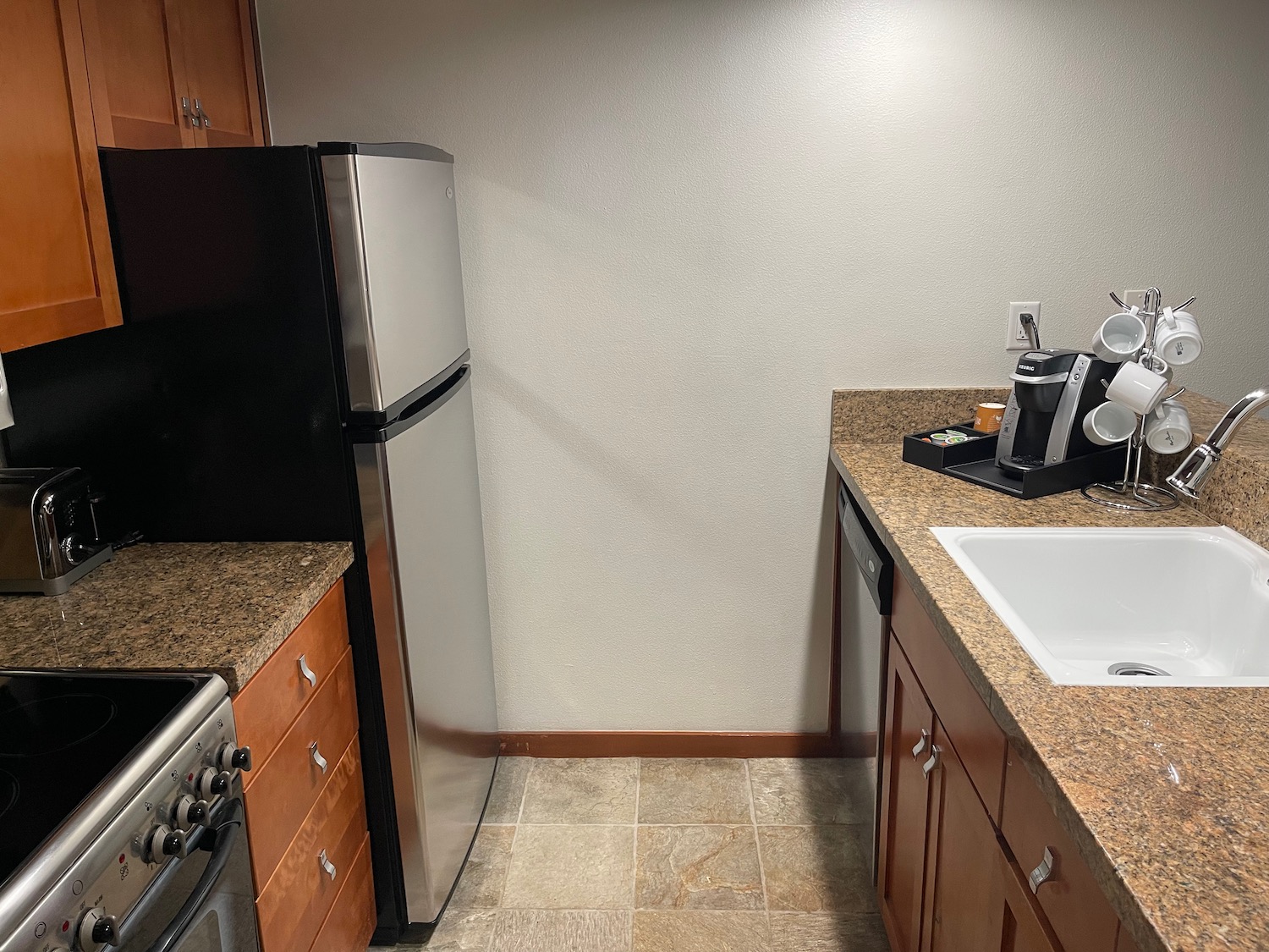 a kitchen with a sink and a refrigerator