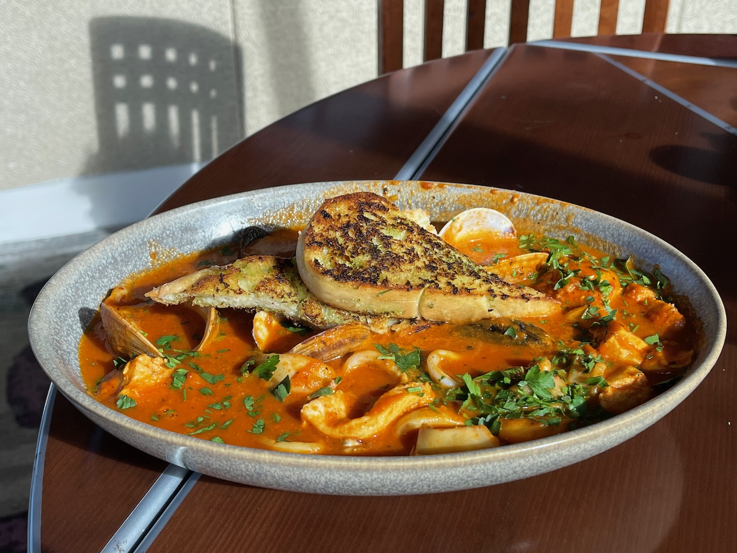 a bowl of soup with toast on top