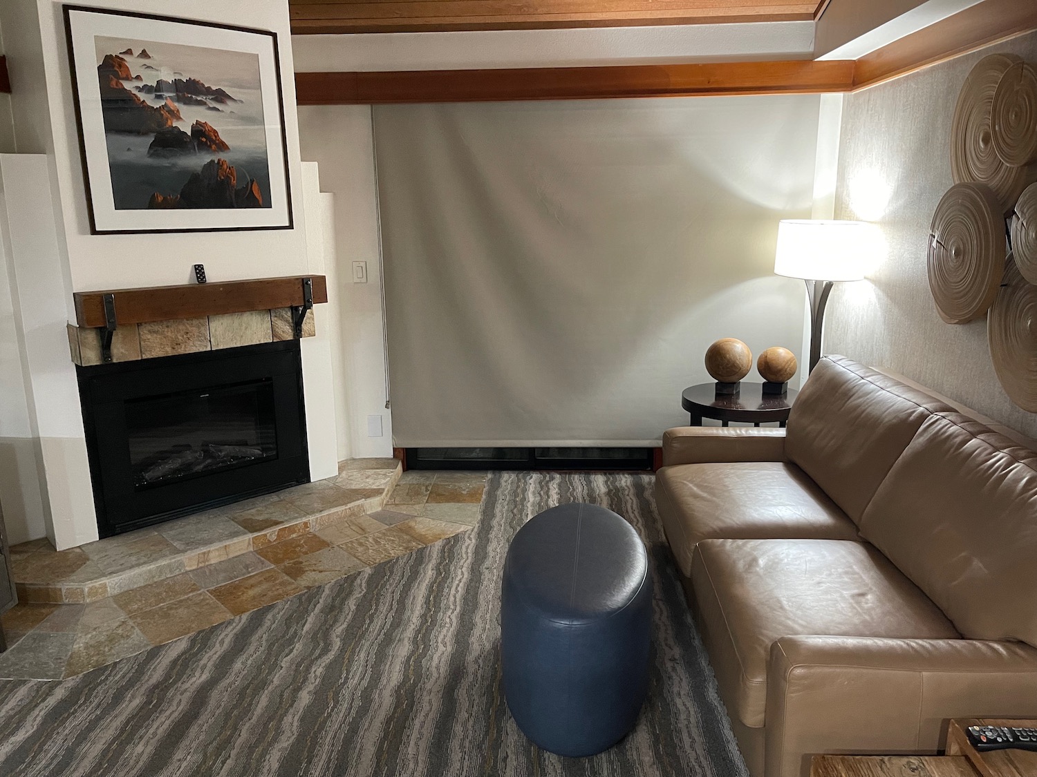 a living room with a leather couch and a fireplace