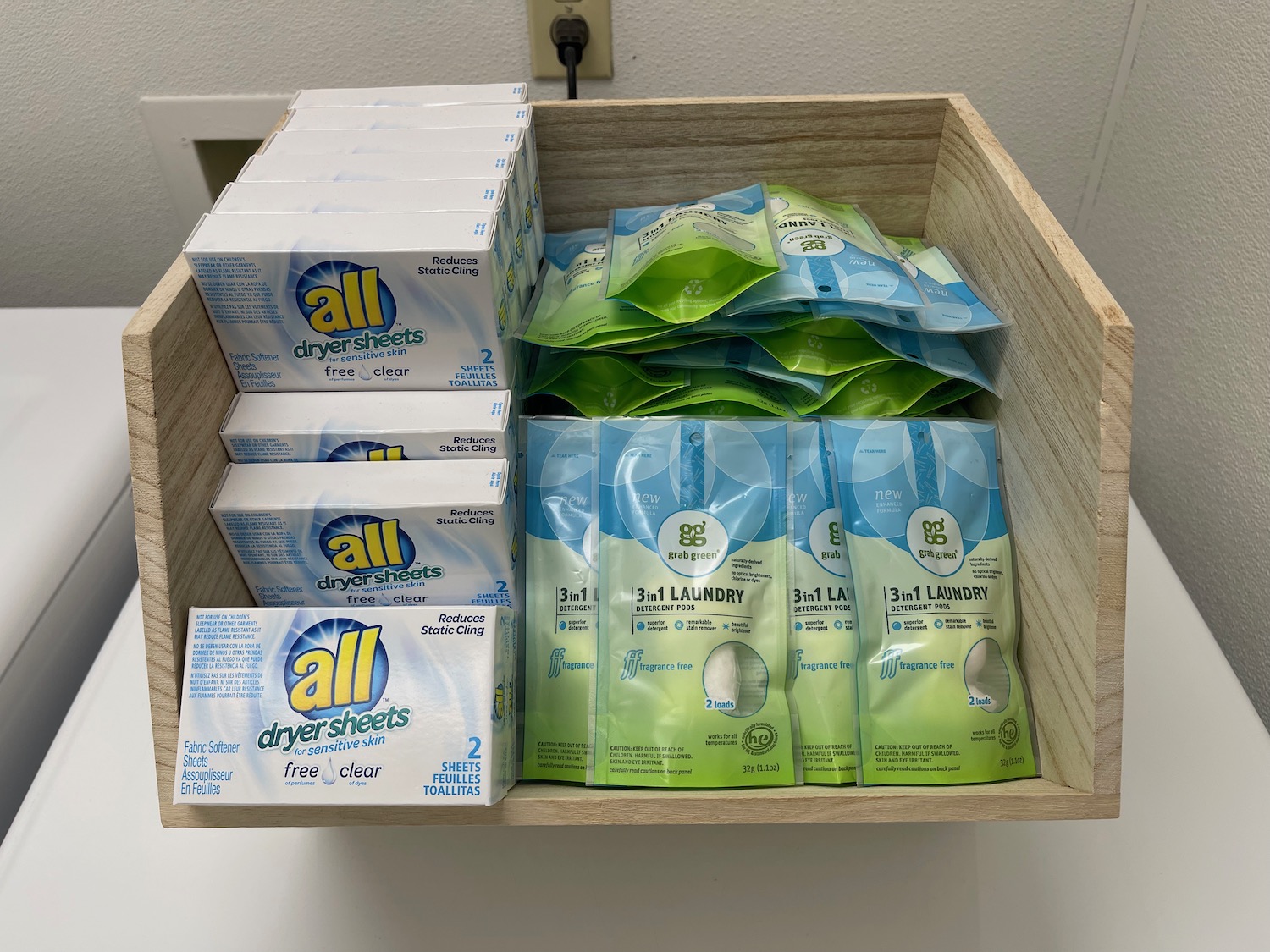 a wooden box with laundry detergents and packages