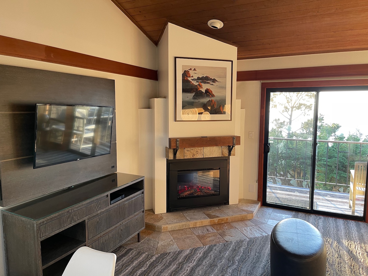 a living room with a fireplace and a glass door